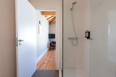 a bathroom with a shower and a glass door at Cedofeita Deluxe Apartment 3B in Porto