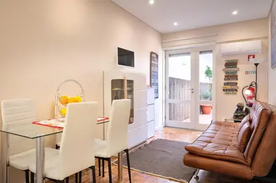 a kitchen and dining room with a table and chairs at Refugio in Porto