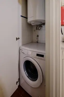 a washer and dryer in a small room at BOUTIQUE Rentals-Flores Plaza in city historical center in Porto