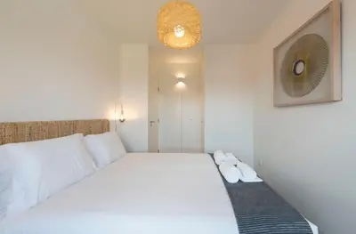a bedroom with a white bed with two pairs of shoes at LovelyStay - Gorgeous Modern Flat w/ Balcony in Porto