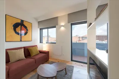 a living room with a couch and a table at LovelyStay - Gorgeous Modern Flat w/ Balcony in Porto