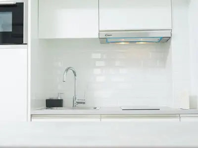 a white kitchen with a sink and a microwave at Angel Flats in Porto