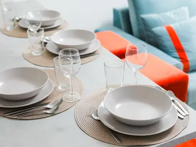 a table with plates and wine glasses on it at Angel Flats in Porto