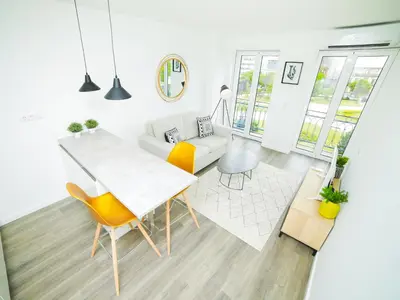 a white living room with a table and chairs at Angel Flat in Porto