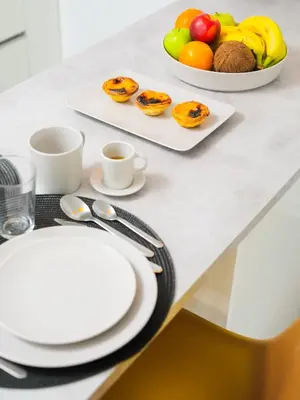 a table with plates and cups and fruit on it at Angel Flat in Porto