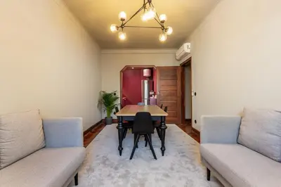 a dining room with a table and two couches at YOUROPO - Santa Catarina in Porto