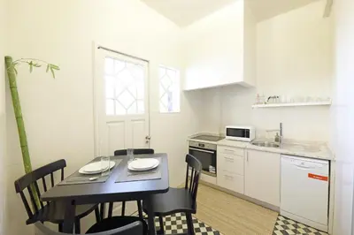 a kitchen with a table and chairs in a kitchen at FLH Porto Spacious Flat in Porto