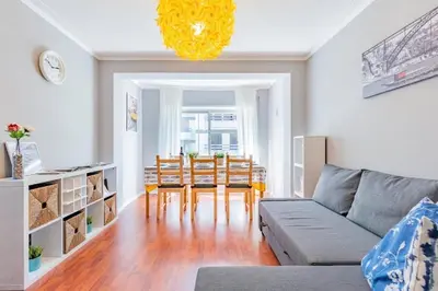 a living room with a couch and a table and chairs at Apartamento Lar doce Lar Porto in Vila Nova de Gaia