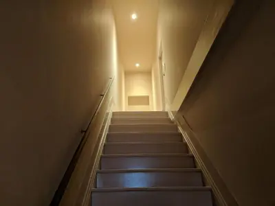 a stairway leading up to a room with a door at Marias River Apartment in Porto