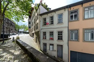 an old building on the side of a street at Marias River Apartment in Porto