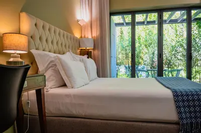 a room with a bed and a table and a chair at Jardim da Batalha Boutique Hotel by Shiadu in Porto