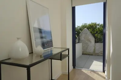a glass table with a vase and a glass window at Oporto Wall Apartments in Porto