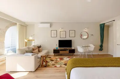 a living room with a television on a table at Boavista Garden Studio 183 in Porto