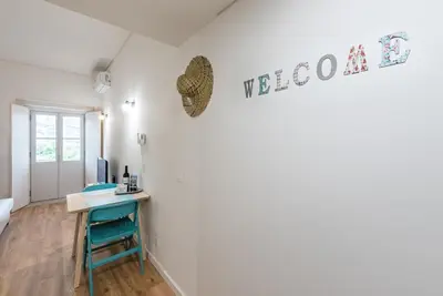 a room with a desk and a computer on a wall at GuestReady - Bay Watch in Porto
