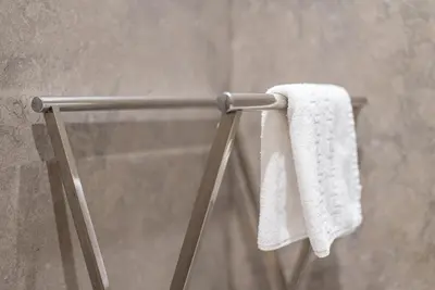 a towel hanging on a towel rack in a shower at GuestReady - Grit & Glam in Porto
