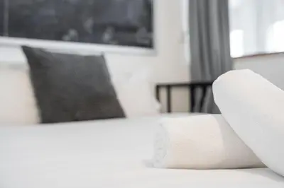 a white couch sitting in a living room next to a window at GuestReady - Paragon in Porto in Porto