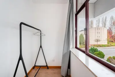 a floor lamp in a room with a window at GuestReady - Paragon in Porto in Porto
