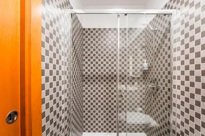a bathroom with a glass shower with a toilet at GuestReady - Paragon in Porto in Porto