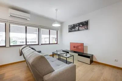 a living room with a couch and a table at GuestReady - Paragon in Porto in Porto