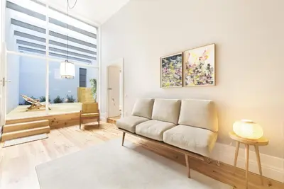 a living room with a couch and a window at Tripas-Coração, Santa Teresa in Porto