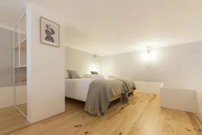 two white beds in a room with a window at Tripas-Coração, Santa Teresa in Porto