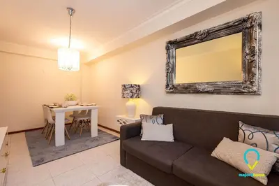 a living room with a couch and a table at Camilo Apartment in Porto