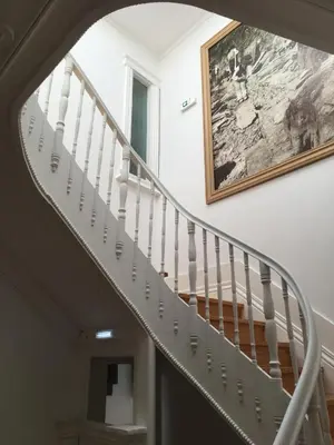 a staircase in a house with a picture on the wall at Pimms Home Ribeira in Porto