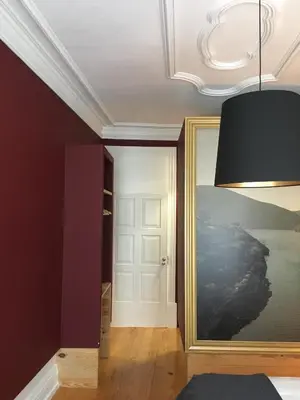 a room with a door and a painting on the wall at Pimms Home Ribeira in Porto