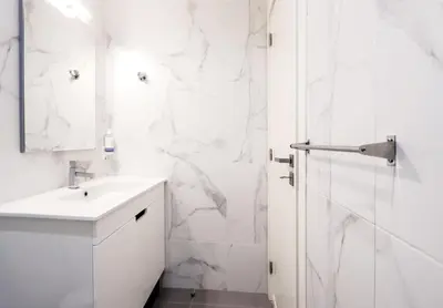 a white bathroom with a sink and a shower at HM - Nearby Bolhão Studio in Porto