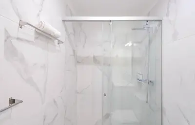 a white bathroom with a shower with a glass door at HM - Nearby Bolhão Studio in Porto