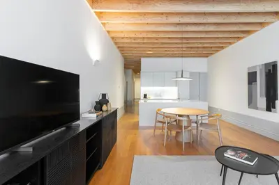 a living room with a large television and a table at Mouzinho Village River in Porto