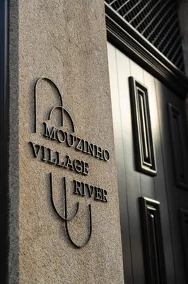 a sign on the side of a building at Mouzinho Village River in Porto