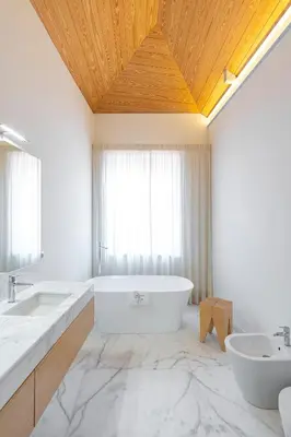 a bathroom with a large tub and two sinks at Mouzinho Village River in Porto