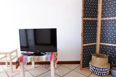 a tv sitting on a table in a living room at Kame House in Vila Nova de Gaia