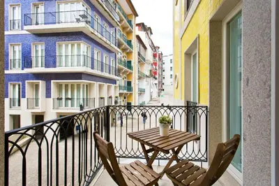 a balcony with a table and chairs on a balcony at Cardosas Square Apartments by Porto City Hosts in Porto