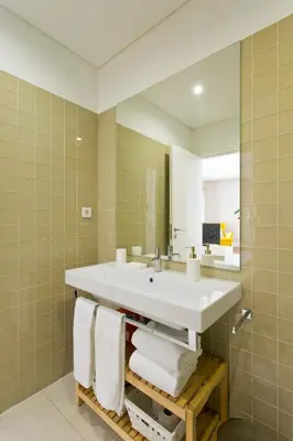 a bedroom with a large bed with two towels on it at Cardosas Square Apartments by Porto City Hosts in Porto