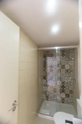 a shower with a glass door in a bathroom at Picasso Suites Porto by PCH in Porto