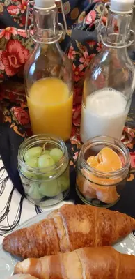 a table with a plate of food and glass bottles of milk at Lemago Porto Apartments - Sé in Porto