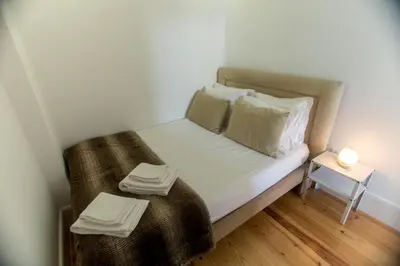 a small bedroom with a bed with towels on it at Santa Catarina Views by Porto City Hosts in Porto