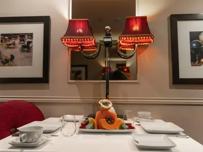 a table with two lamps and a plate of food on it at Guest House Douro in Porto