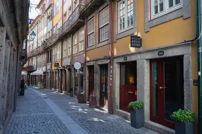 an empty street in a city with buildings at Guest House Douro in Porto