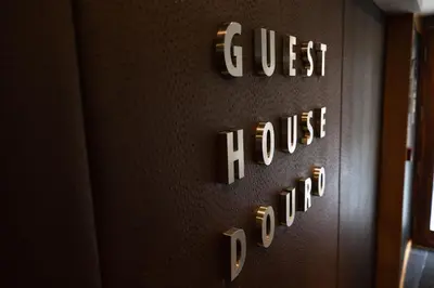 a wall with a sign that reads guest house at Guest House Douro in Porto