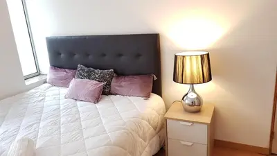 a bedroom with a bed and a lamp on a night stand at Oporto Beauty Flat in Porto