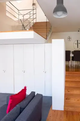 a living room with a couch and a staircase at Casas do Teatro in Porto