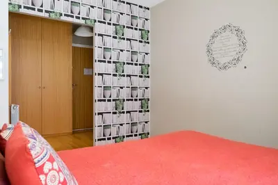 a bedroom with a wall of pictures on the wall at Casas do Teatro in Porto