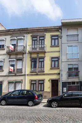 two cars parked in front of a building at ZD Moreira Flats A By PortoProperties4You in Porto
