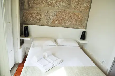 a bedroom with a bed with a towel on it at ZD Moreira Flats E By PortoProperties4You in Porto