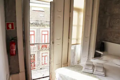a room with a bed and a window with a view at ZD Moreira Flats E By PortoProperties4You in Porto