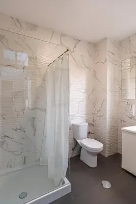 a white bathroom with a toilet and a shower at ZD Moreira Flats E By PortoProperties4You in Porto