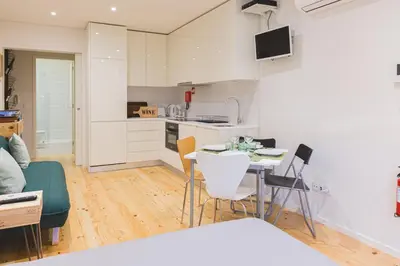 a kitchen and living room with a table and chairs at APOSENTUS - The Wine Studio in Porto